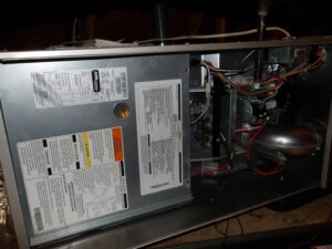 Attic furnace with the front panel removed during a Lexington, KY home inspection