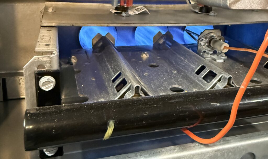 Gas furnace burners with the access panel open during a home inspection